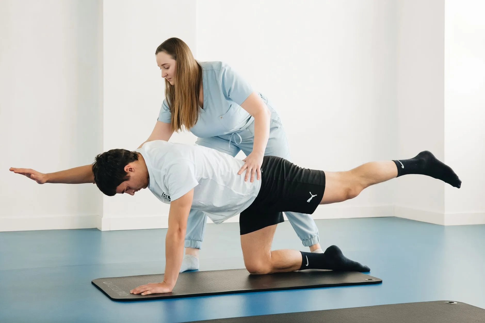 Fisioterapeuta orientando exercício de fortalecimento do core em paciente
